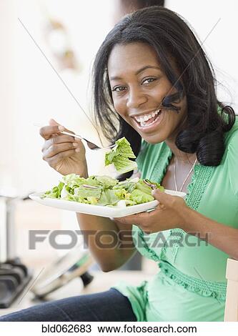 African woman eating salad View Large Photo Image Stock Image - African woman eating salad. Fotosearch