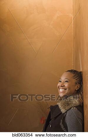 Picture - African woman looking up and smiling. Fotosearch