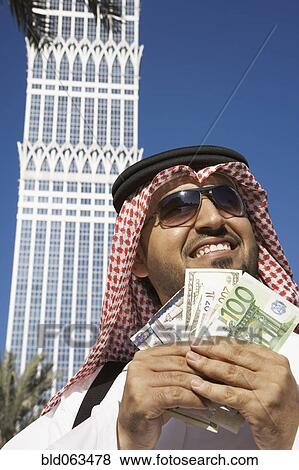 Arab man holding money View Large Photo Image Stock Photo - Arab man holding money. Fotosearch