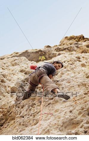 Picture - Argentinean man rock climbing. Fotosearch