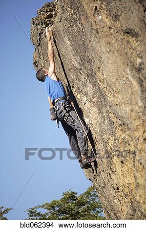 Picture - Argentinean man rock climbing. Fotosearch