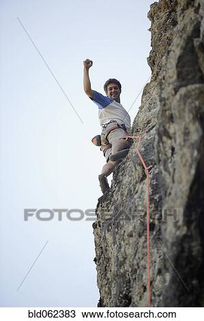 Stock Image - Argentinean man rock climbing. Fotosearch