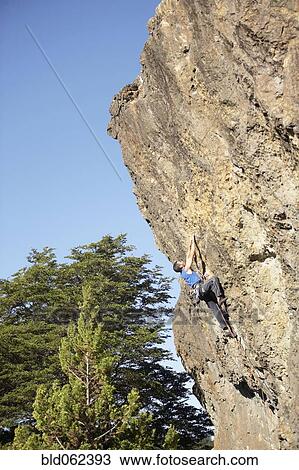 Stock Image - Argentinean man rock climbing. Fotosearch