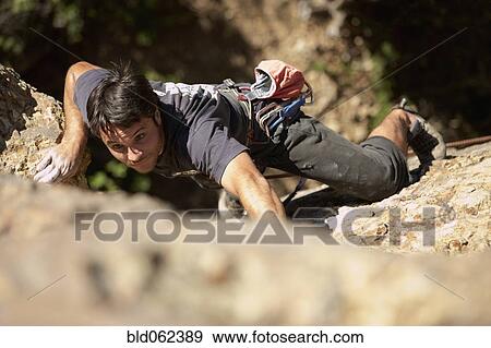 Stock Photo - Argentinean man rock climbing. Fotosearch