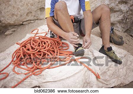 Argentinean rock climber fastening shoes View Large Photo Image Stock Photograph - Argentinean rock climber fastening shoes. Fotosearch