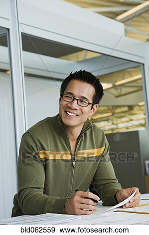 Asian American businessman working in office View Large Photo Image Stock Photo - Asian American businessman working in office. Fotosearch