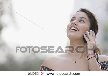 Brazilian teenager talking cell phone looking up View Large Photo Image Picture - Brazilian teenager talking cell phone looking up. Fotosearch