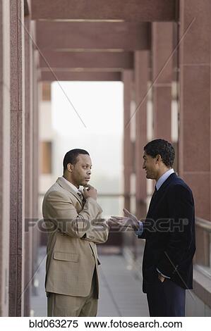 Stock Photography - Businessmen talking outside. Fotosearch