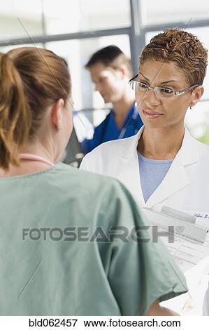 Stock Photo - Cape Verde doctor consulting with nurse. Fotosearch