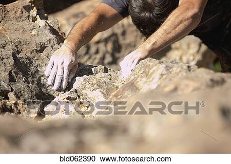 Stock Image - Close of up of chalk on Argentinean rock climber's hands. Fotosearch