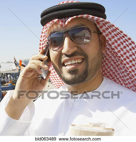 Close up of Arab man talking on cell phone View Large Photo Image Stock Photo - Close up of Arab man talking on cell phone. Fotosearch