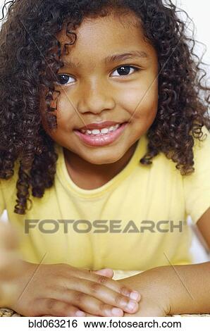 Stock Photograph - Close up of mixed race girl smiling. Fotosearch