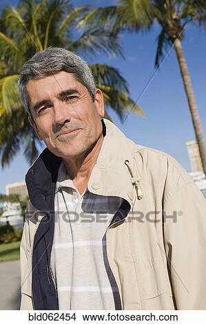 Cuban man standing in front of palm trees View Large Photo Image Picture - Cuban man standing in front of palm trees. Fotosearch