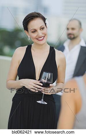 Stock Image - Cuban woman holding wine glass. Fotosearch
