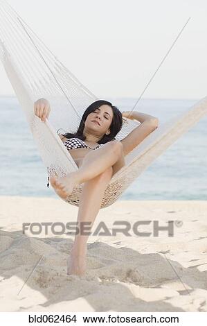 Cuban woman laying in hammock on beach View Large Photo Image Picture - Cuban woman laying in hammock on beach. Fotosearch