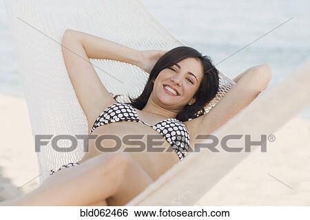 Cuban woman laying in hammock on beach View Large Photo Image Stock Photograph - Cuban woman laying in hammock on beach. Fotosearch