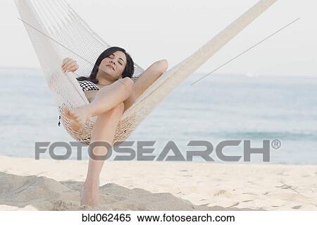 Cuban woman laying in hammock on beach View Large Photo Image Stock Photography - Cuban woman laying in hammock on beach. Fotosearch
