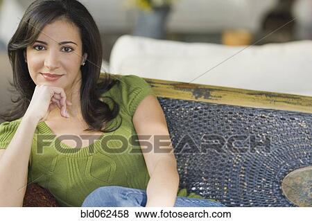 Stock Photo - Cuban woman sitting on sofa. Fotosearch