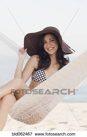Cuban woman wearing hat in hammock on beach View Large Photo Image Stock Photo - Cuban woman wearing hat in hammock on beach. Fotosearch