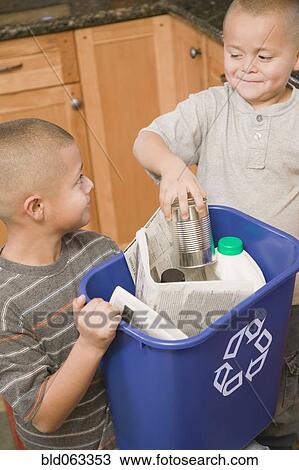 Stock Image - Hispanic brothers recycling. Fotosearch