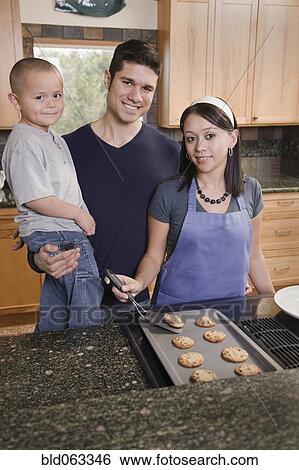 Hispanic family baking cookies in kitchen View Large Photo Image Stock Photograph - Hispanic family baking cookies in kitchen. Fotosearch