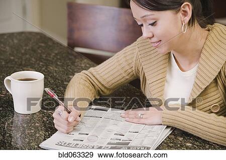 Hispanic woman searching newspaper classified ads View Large Photo Image Stock Photo - Hispanic woman searching newspaper classified ads. Fotosearch