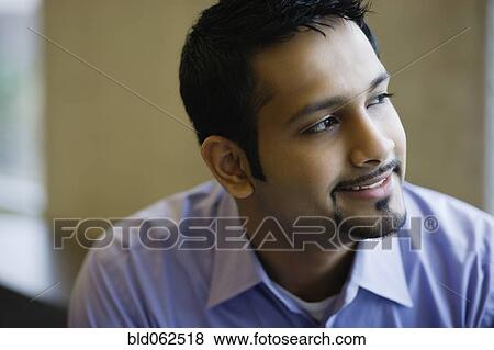 Indian businessman looking pensive View Large Photo Image Stock Photo - Indian businessman looking pensive. Fotosearch