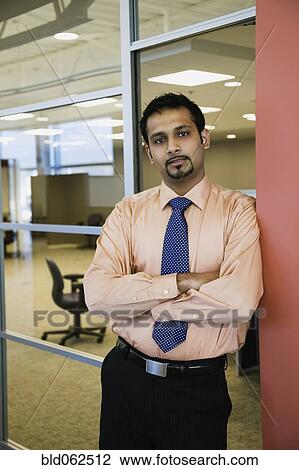 Indian businessman looking serious in office View Large Photo Image Stock Image - Indian businessman looking serious in office. Fotosearch
