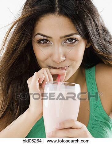 Middle Eastern woman drinking smoothie View Large Photo Image Stock Image - Middle Eastern woman drinking smoothie. Fotosearch