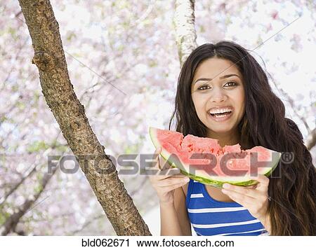 Middle Eastern woman eating watermelon View Large Photo Image Stock Image - Middle Eastern woman eating watermelon. Fotosearch