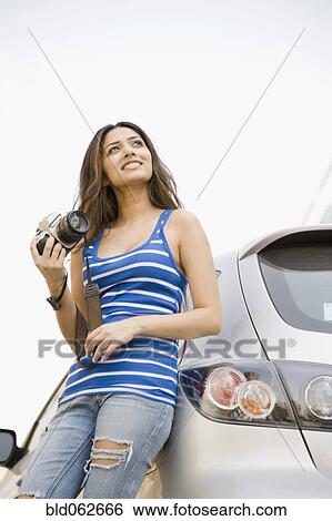 Middle Eastern woman holding camera View Large Photo Image Stock Photograph - Middle Eastern woman holding camera. Fotosearch