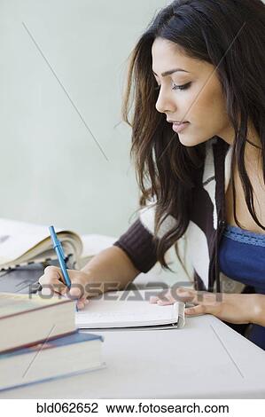 Stock Image - Middle Eastern woman studying. Fotosearch