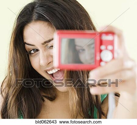 Stock Image - Middle Eastern woman taking self-portrait. Fotosearch