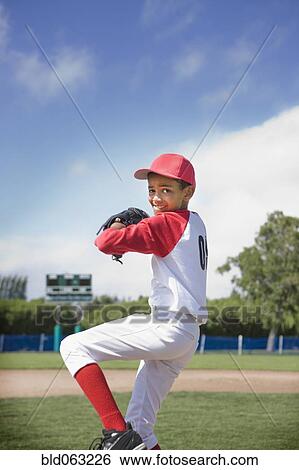 Mixed race boy pitching in baseball game View Large Photo Image Stock Photograph - Mixed race boy pitching in baseball game. Fotosearch