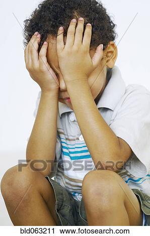 Mixed race boy with head in hands View Large Photo Image Stock Image - Mixed race boy with head in hands. Fotosearch