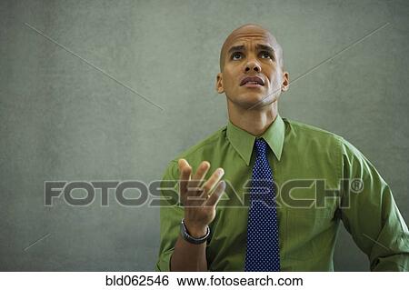 Mixed race businessman gesturing and looking frustrated View Large Photo Image Stock Photograph - Mixed race businessman gesturing and looking frustrated. Fotosearch