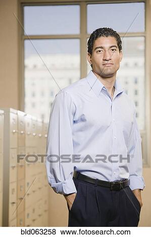 Stock Photo - Mixed race businessman in file room. Fotosearch