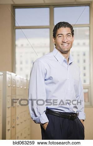 Mixed race businessman in file room View Large Photo Image Stock Photo - Mixed race businessman in file room. Fotosearch