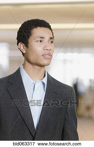 Mixed race businessman looking pensive View Large Photo Image Stock Photo - Mixed race businessman looking pensive. Fotosearch