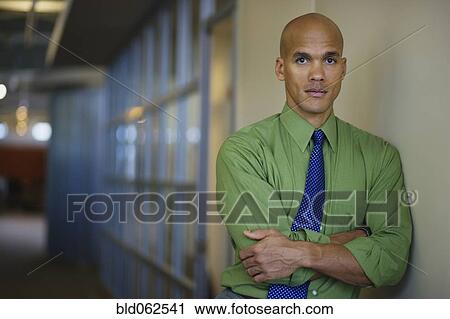 Mixed race businessman looking serious in corridor View Large Photo Image Stock Image - Mixed race businessman looking serious in corridor. Fotosearch