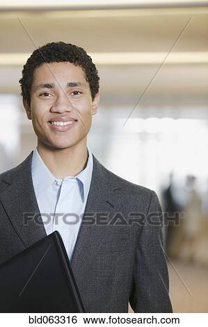 Stock Photograph - Mixed race businessman smiling. Fotosearch