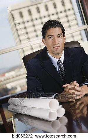 Mixed race businessman with blueprints View Large Photo Image Stock Image - Mixed race businessman with blueprints. Fotosearch