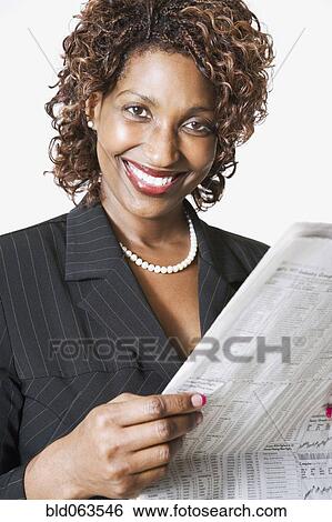 Stock Photograph - Mixed race businesswoman holding newspaper. Fotosearch