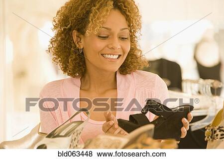 Mixed race woman shoe shopping View Large Photo Image Stock Photo - Mixed race woman shoe shopping. Fotosearch