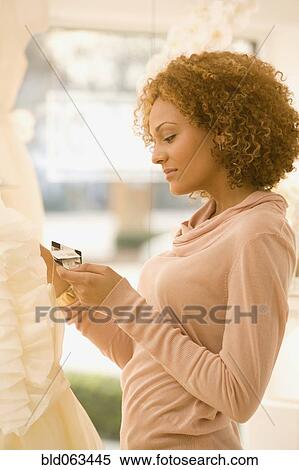 Stock Photography - Mixed race woman shopping. Fotosearch
