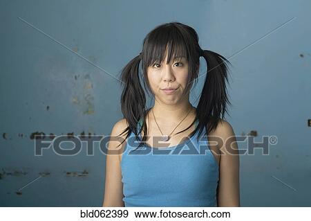 Mixed-race woman with pigtails making silly face View Large Photo Image Stock Photo - Mixed-race woman with pigtails making silly face. Fotosearch