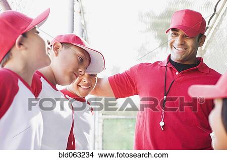 Picture - Multi-ethnic boys in baseball uniforms with coach. Fotosearch