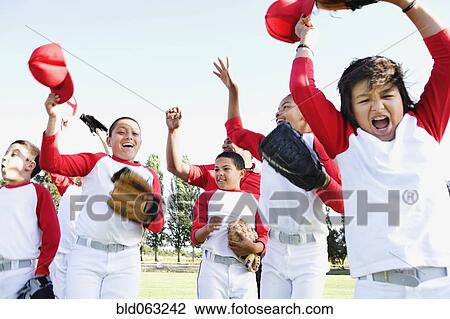 Multi-ethnic boys in baseball uniforms celebrating View Large Photo Image Stock Image - Multi-ethnic boys in baseball uniforms celebrating. Fotosearch