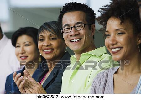 Stock Photo - Multi-ethnic business people clapping. Fotosearch