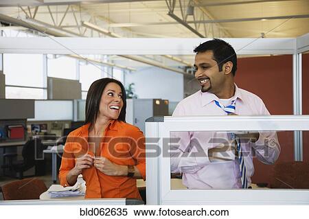 Stock Photography - Multi-ethnic business people dressing in office. Fotosearch